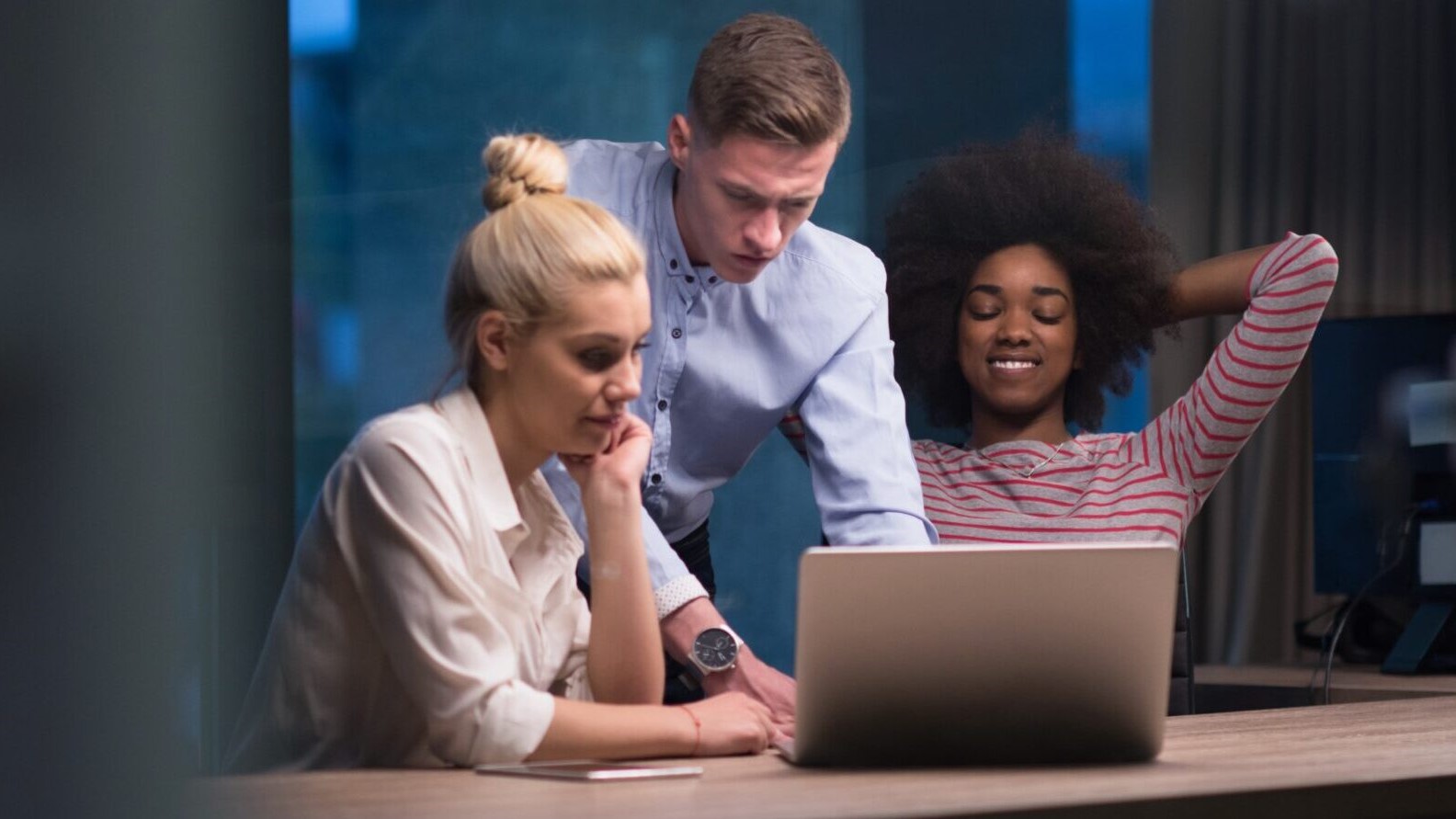 Multiethnic startup business team in night office